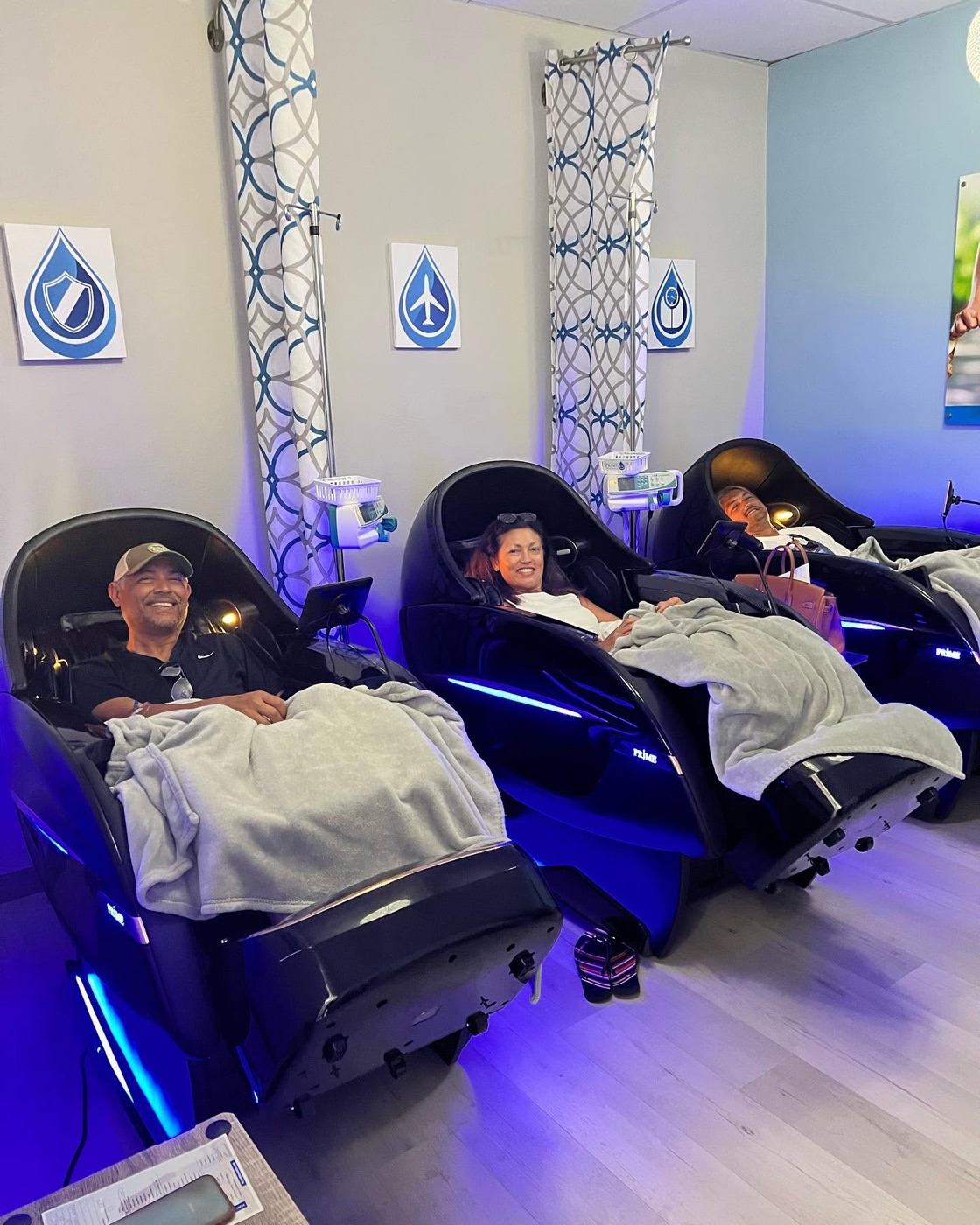 Guests relaxing in heated Prime IV massage chairs
